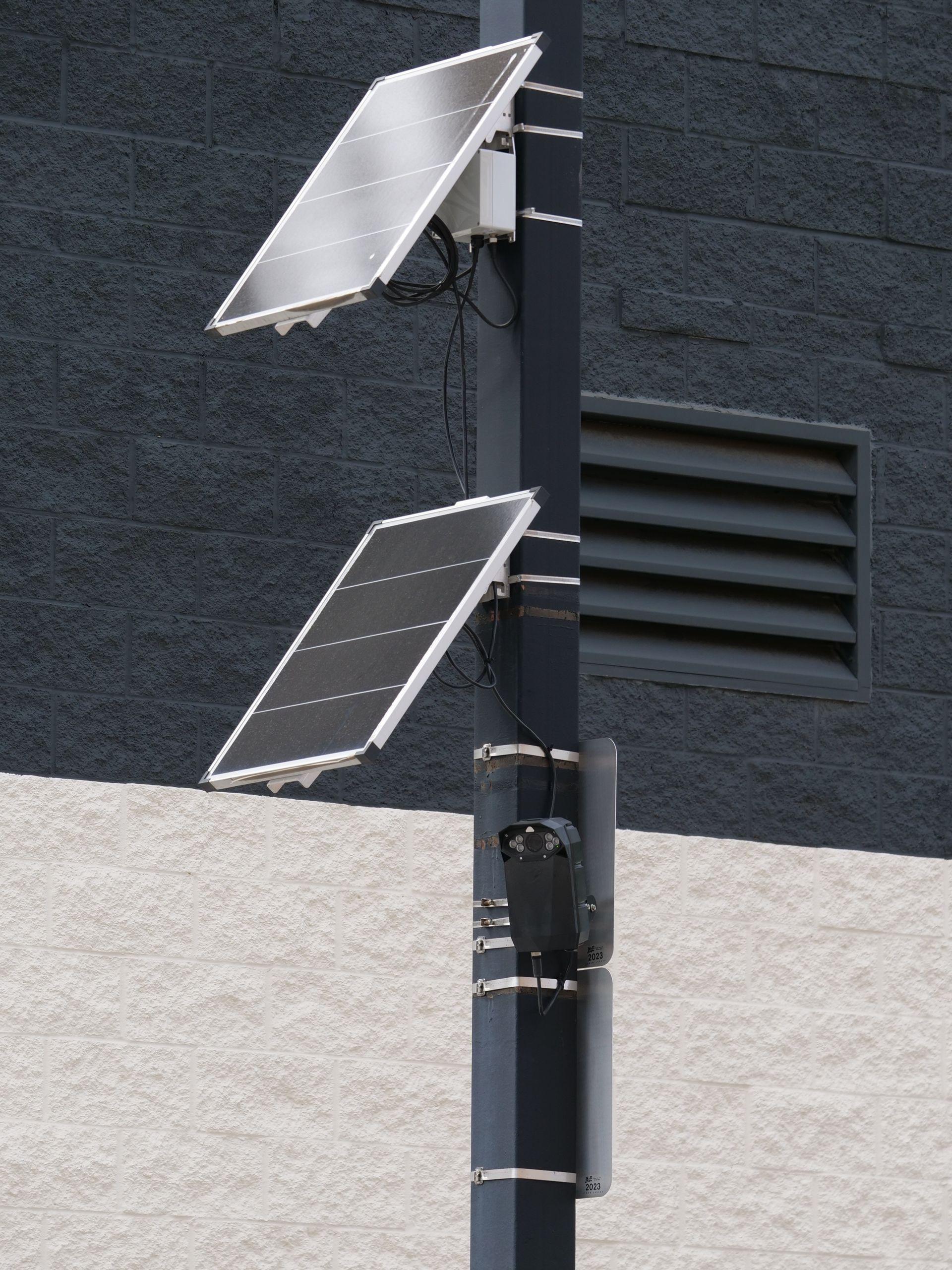 Solar panels and camera mounted on a pole for smart city surveillance.