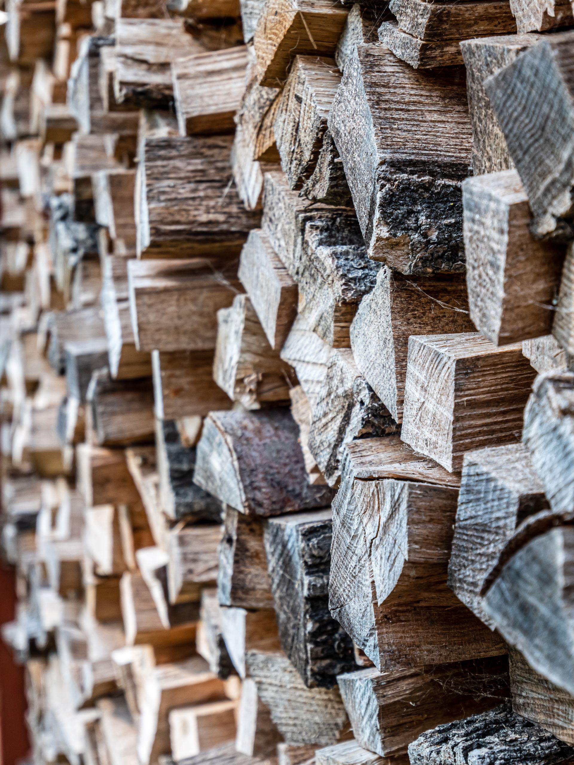 Detailed close-up of neatly stacked firewood showcasing texture and grain.